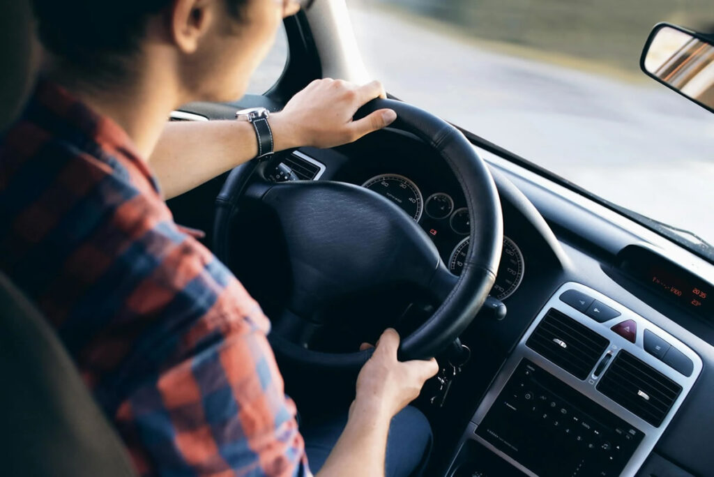 Boy driving the car in New Zealand